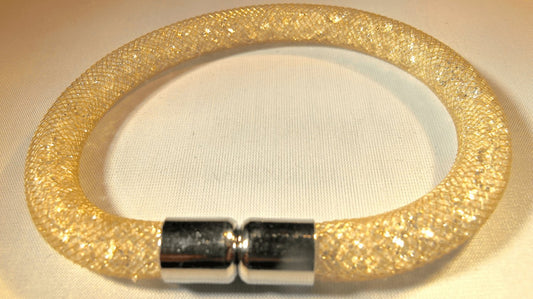 Gold colored bracelet filled with white crystals