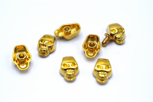 Gold colored loose rivets skulls - 50 pieces