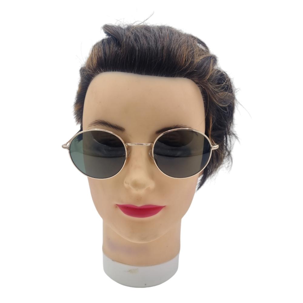 Round sunglasses with dark lenses and gold-colored frames